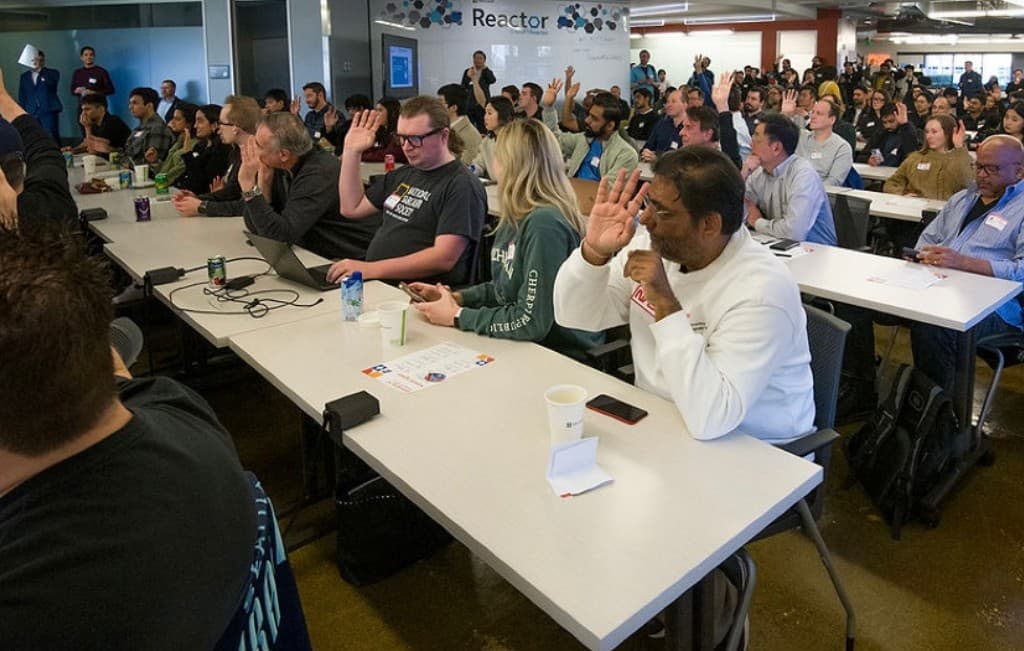 Community gathering with hands raised